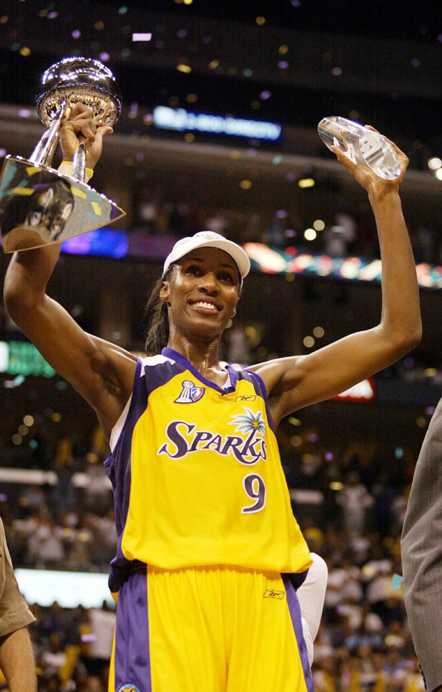 Lisa Leslie #9 of the Los Angeles Sparks holds up the WNBA Championship trophy and the Playoff MVP trophy after game two of the 2002 WNBA Finals against the New York Liberty