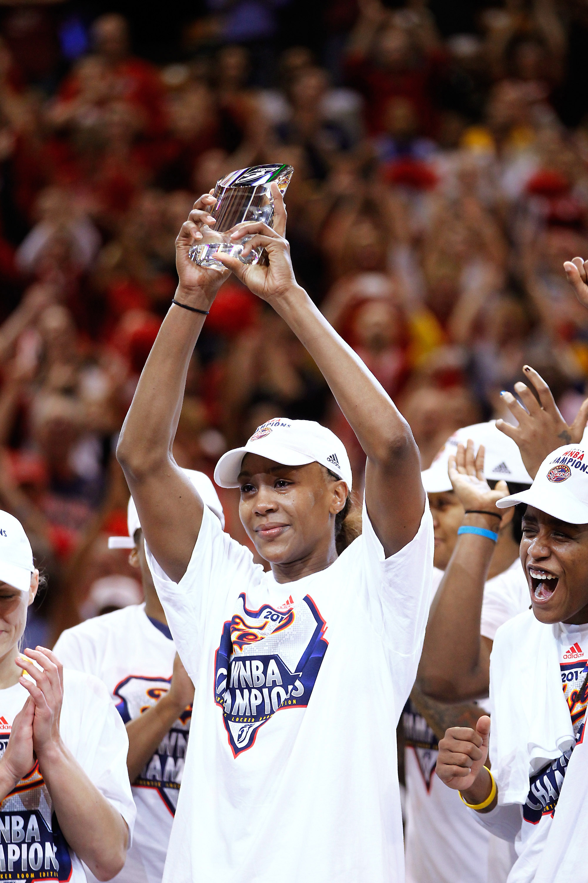 Tamika Catchings #24 of the Indiana Fever hoists the MVP trophy after defeating the Minnesota Lynx during Game Four of the 2012 WNBA Finals