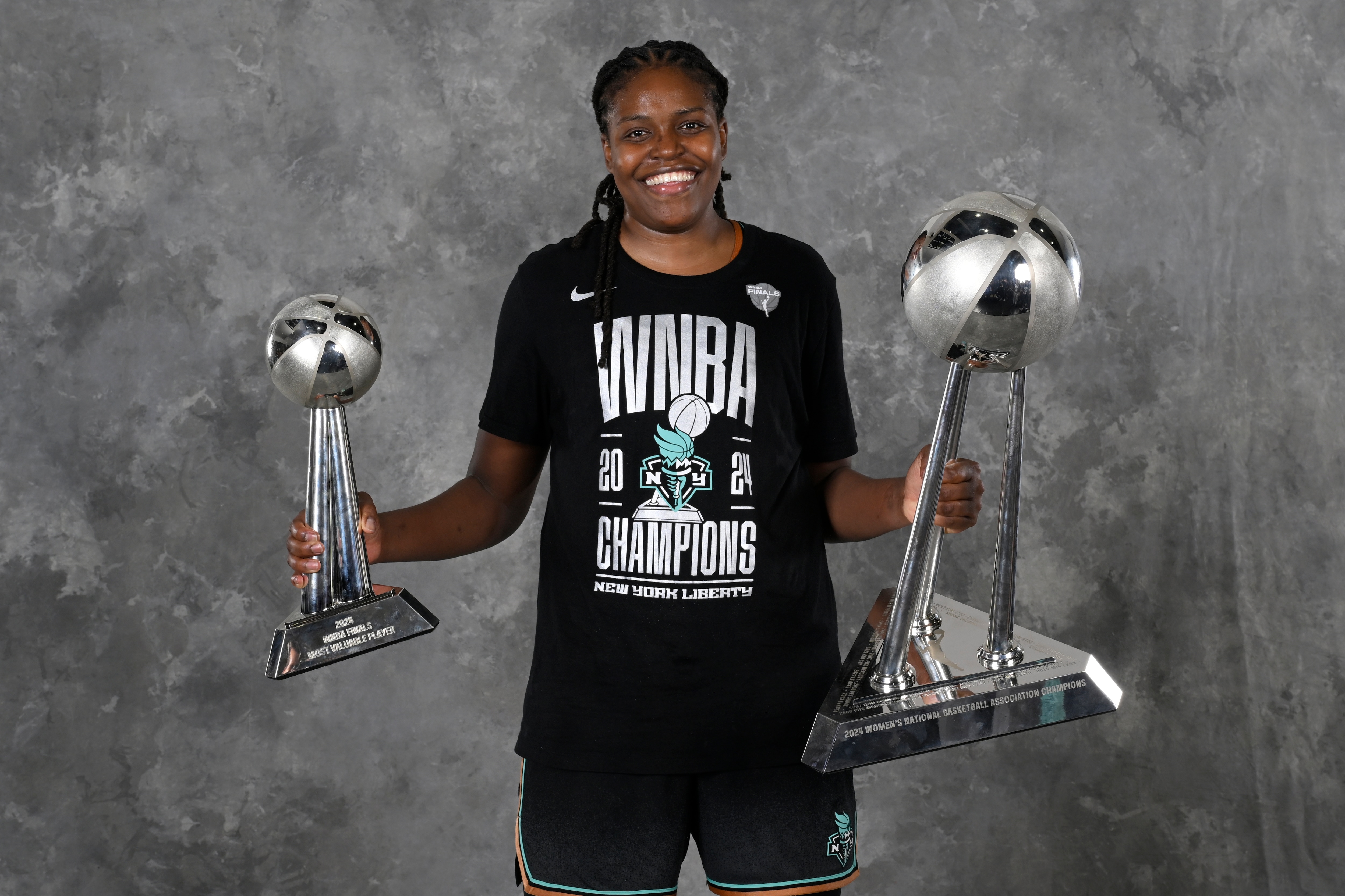 Jonquel Jones #35 of the New York Liberty poses for a portrait with the 2024 WNBA Championship trophy and 2024 WNBA Finals MVP Award