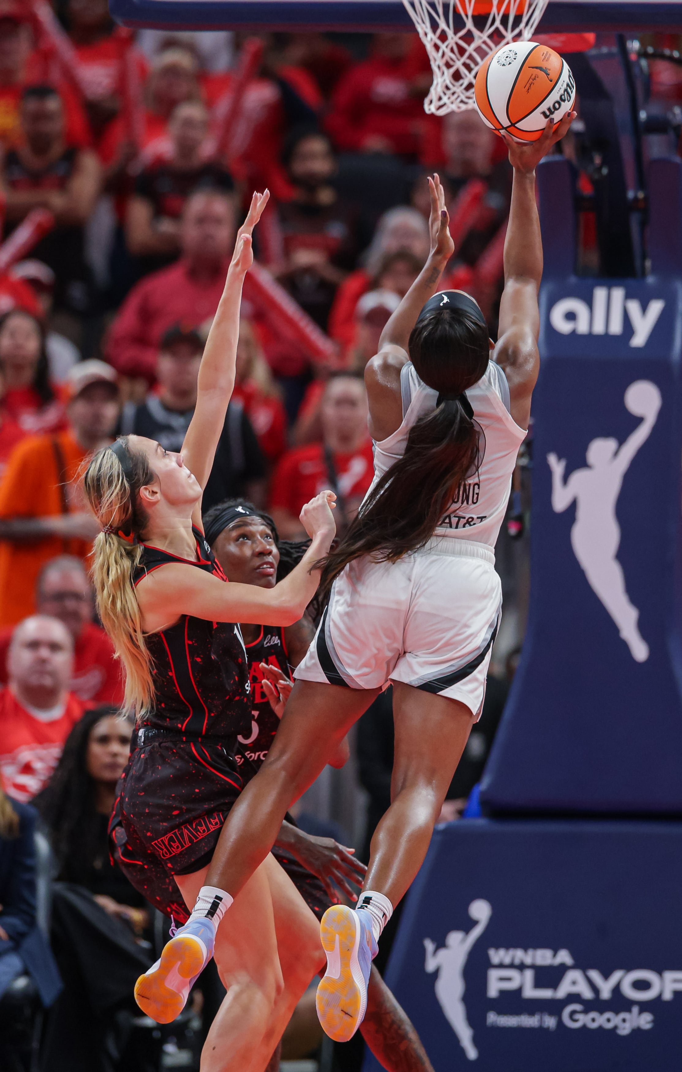 Jackie Young #0 of the Las Vegas Aces shoots the ball against Lexie Hull #10 of the Indiana Fever