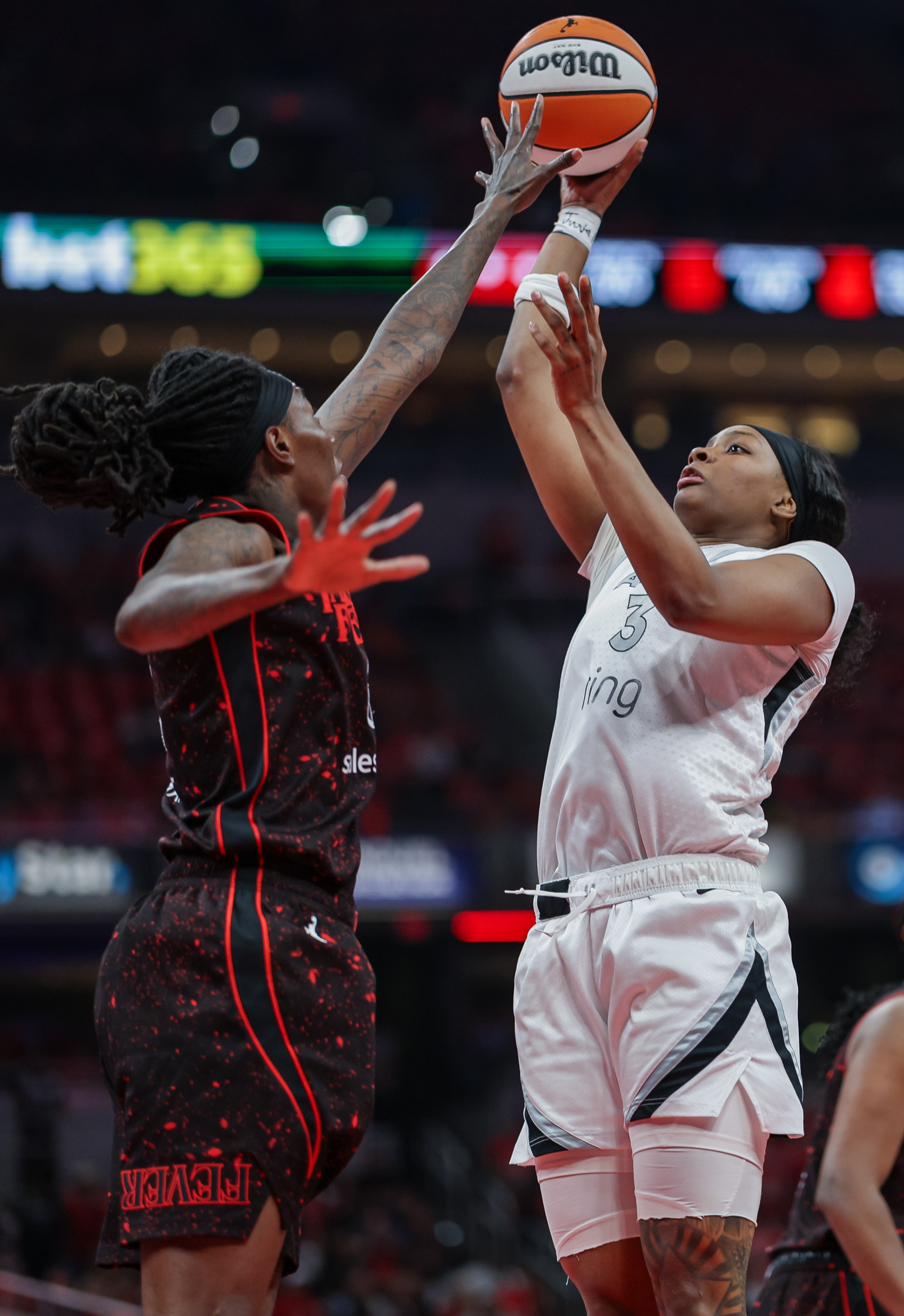 NaLyssa Smith #3 of the Las Vegas Aces shoots the ball against Natasha Howard #6 of the Indiana Fever