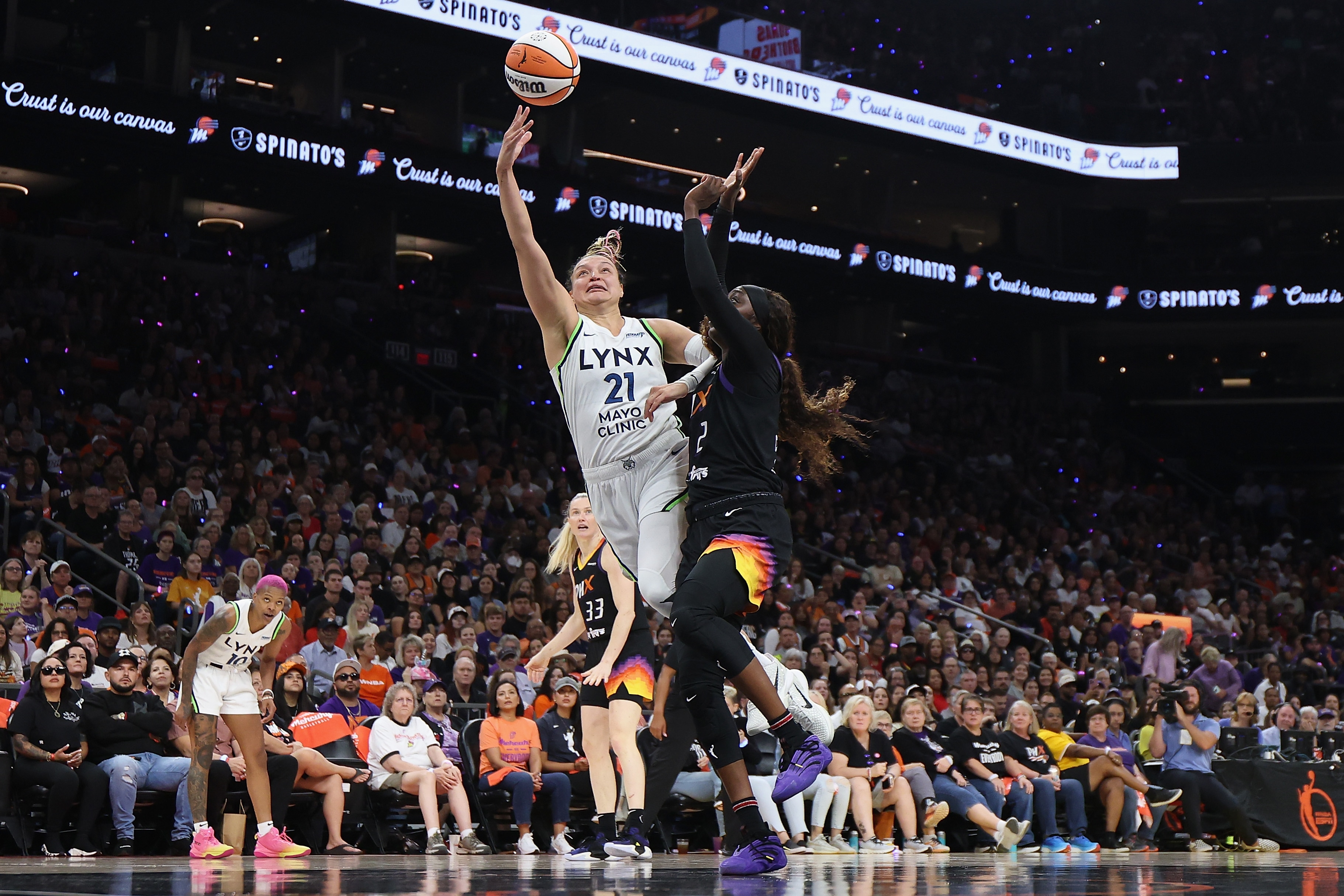 Kayla McBride #21 of the Minnesota Lynx attempts a shot against Kahleah Copper #2 of the Phoenix Mercury