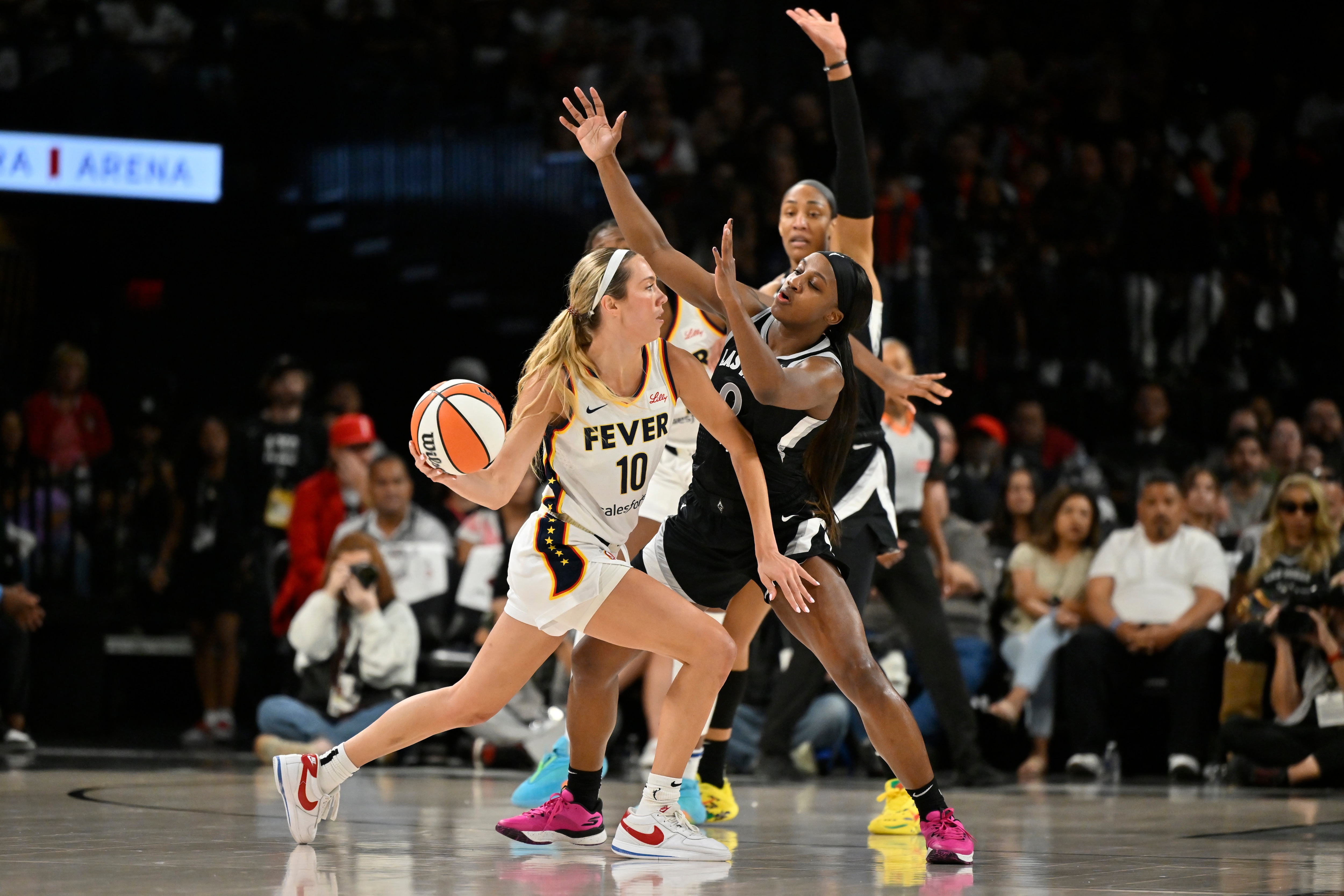 Jackie Young #0 of the Las Vegas Aces plays defense on Lexie Hull #10 of the Indiana Fever