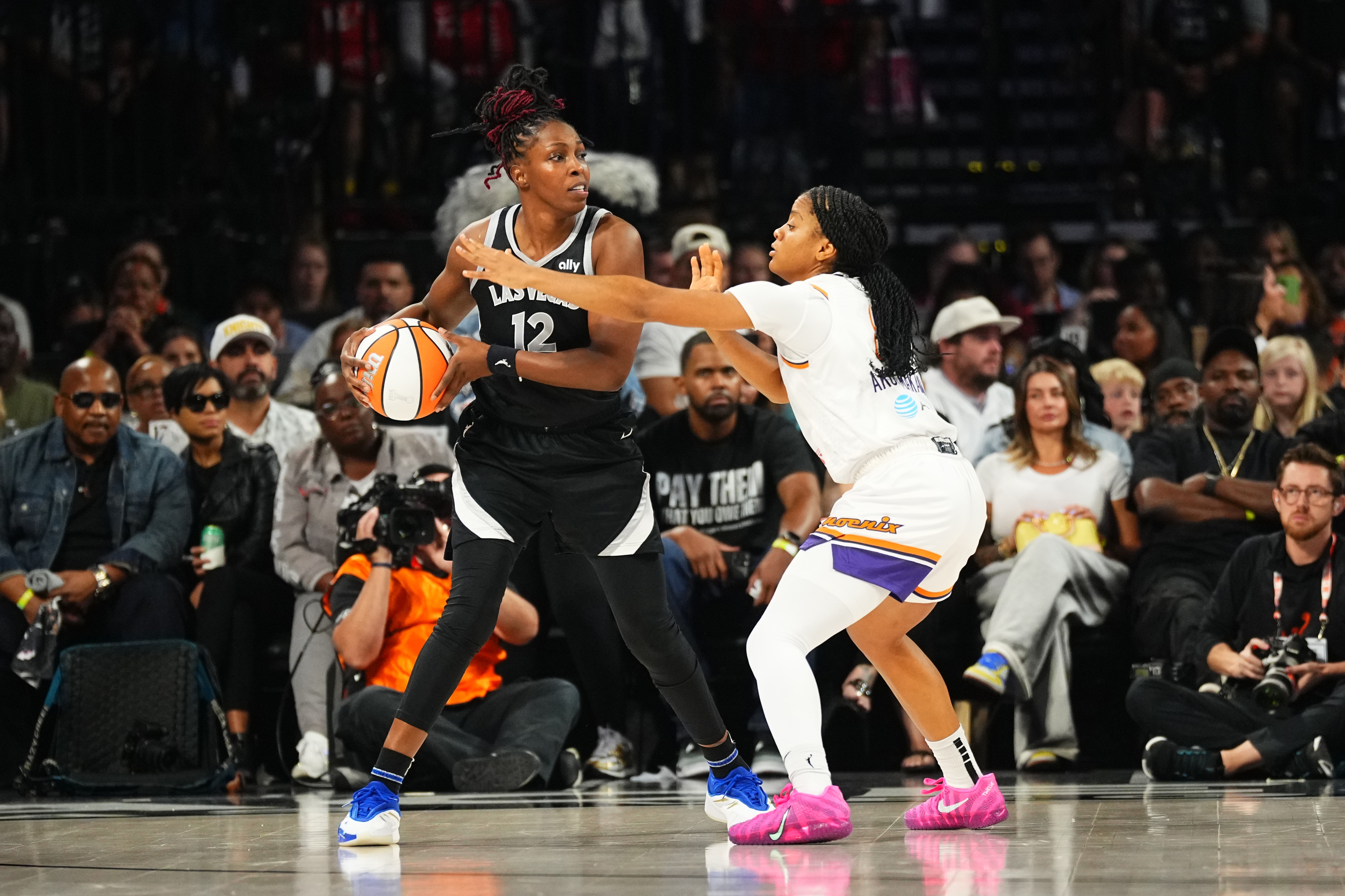 Monique Akoa Makani #8 of the Phoenix Mercury plays defense on Chelsea Gray #12 of the Las Vegas Aces during Game 2 of the 2025 WNBA Finals