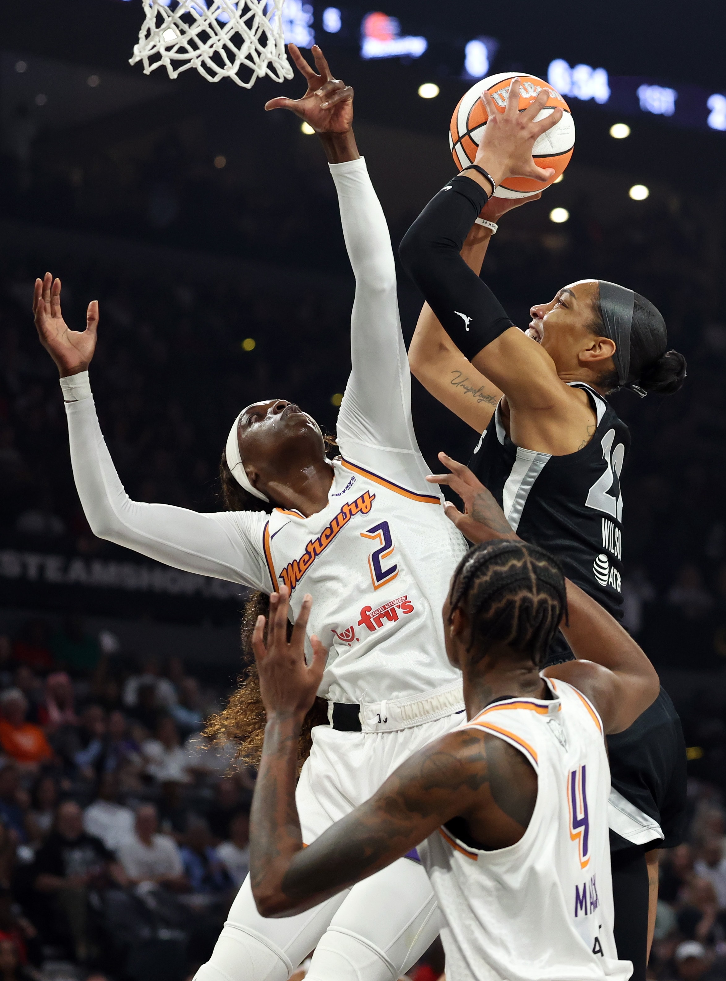 A'ja Wilson #22 of the Las Vegas Aces grabs a rebound against Kahleah Copper #2 of the Phoenix Mercury