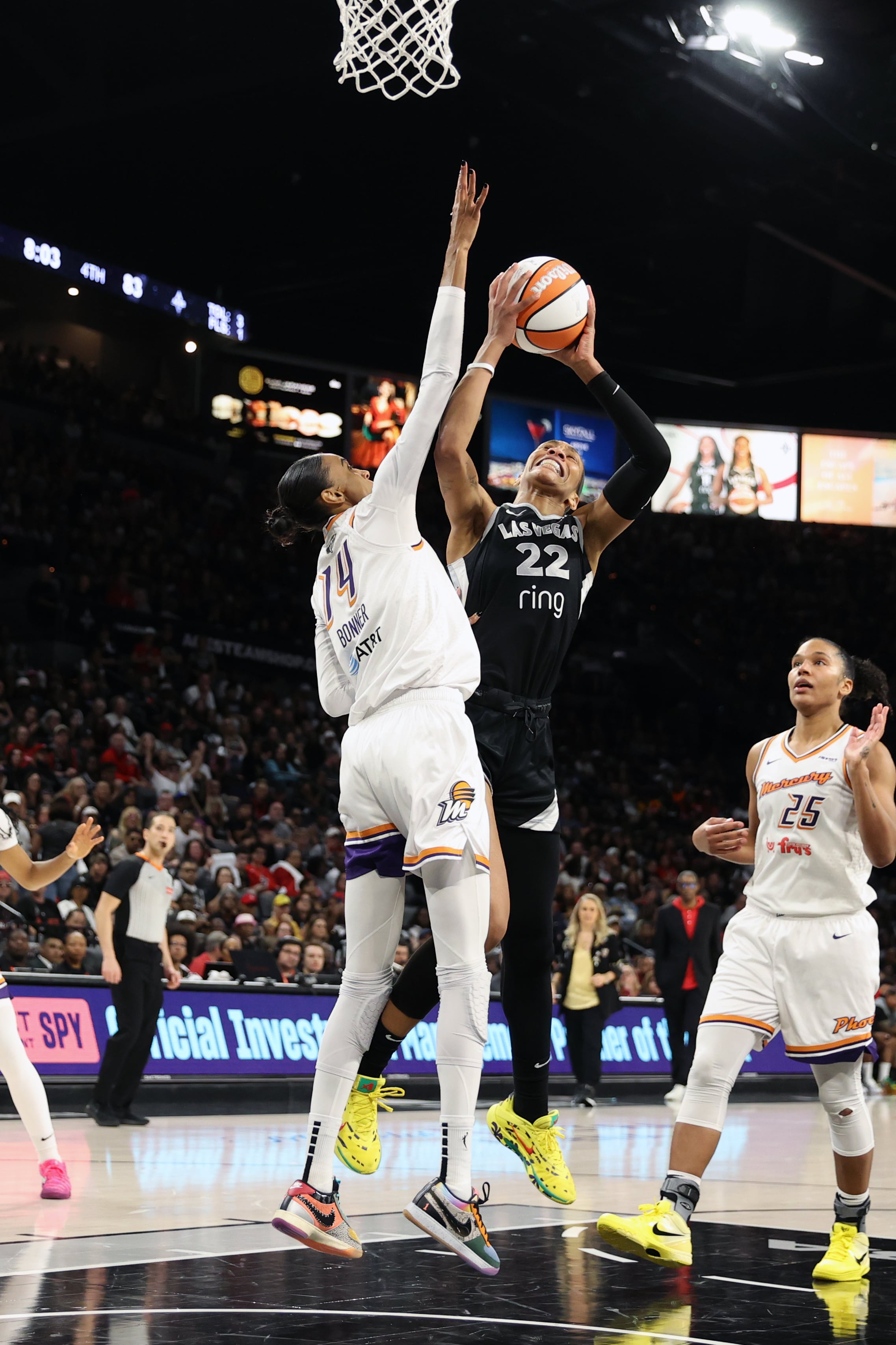 A'ja Wilson #22 of the Las Vegas Aces drives to the basket as DeWanna Bonner #14 of the Phoenix Mercury plays defense