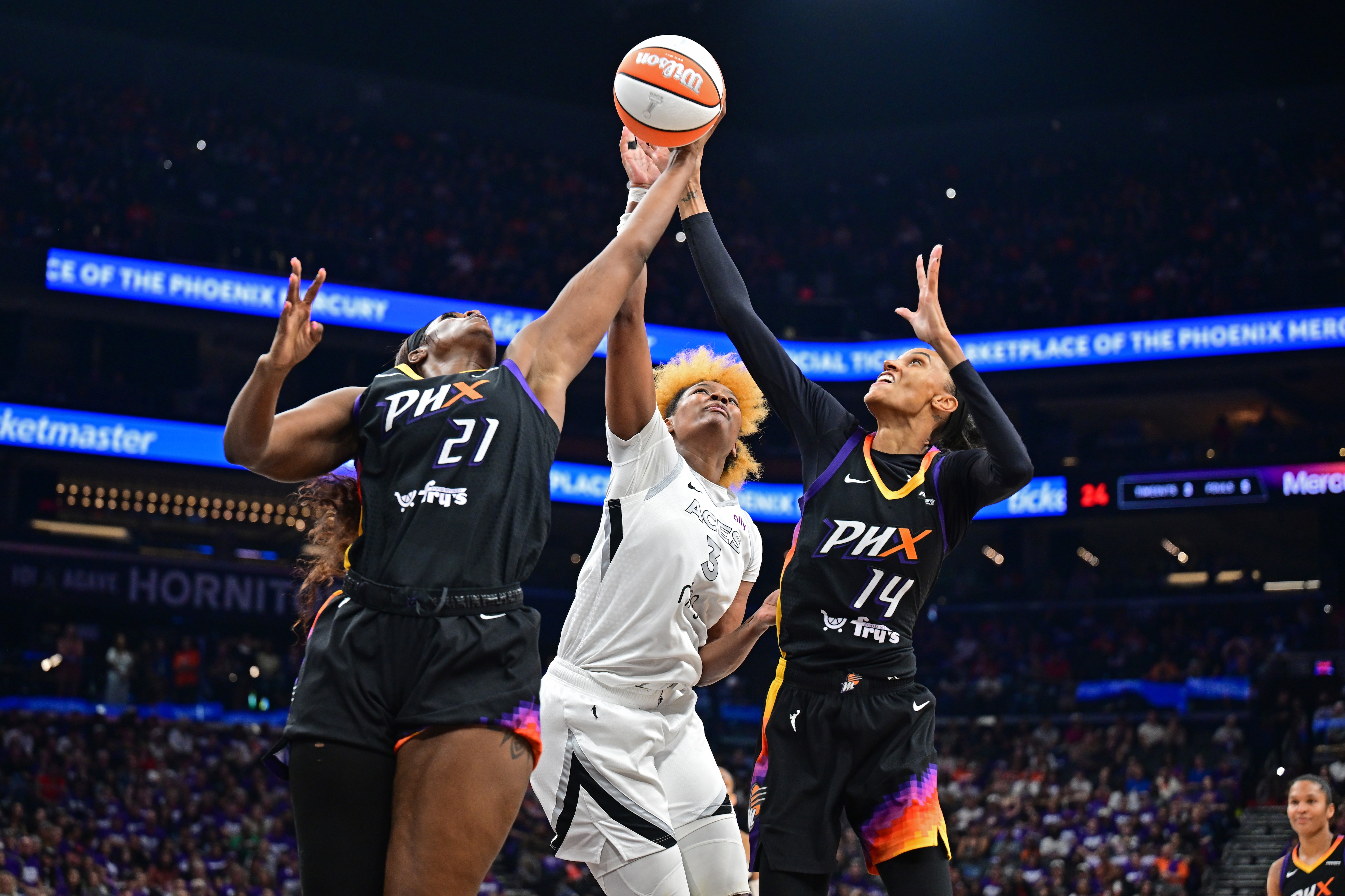 Kalani Brown #21, DeWanna Bonner #14 of the Phoenix Mercury and NaLyssa Smith #3 of the Las Vegas Aces goes up for the rebound