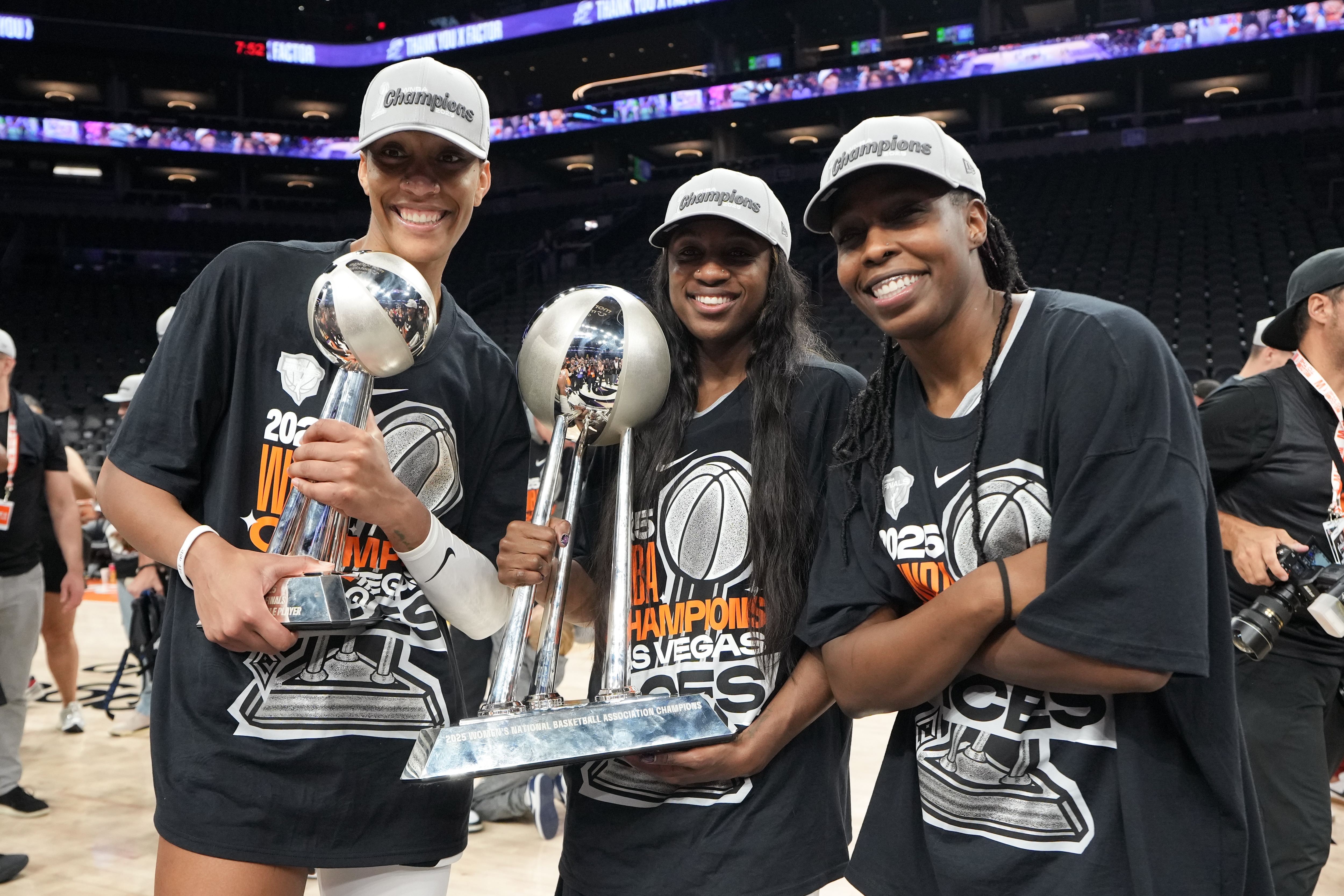 A'ja Wilson #22, Jackie Young #0, and Chelsea Gray #12 of the Las Vegas Aces pose for a photo with the 2025 WNBA Championship trophy