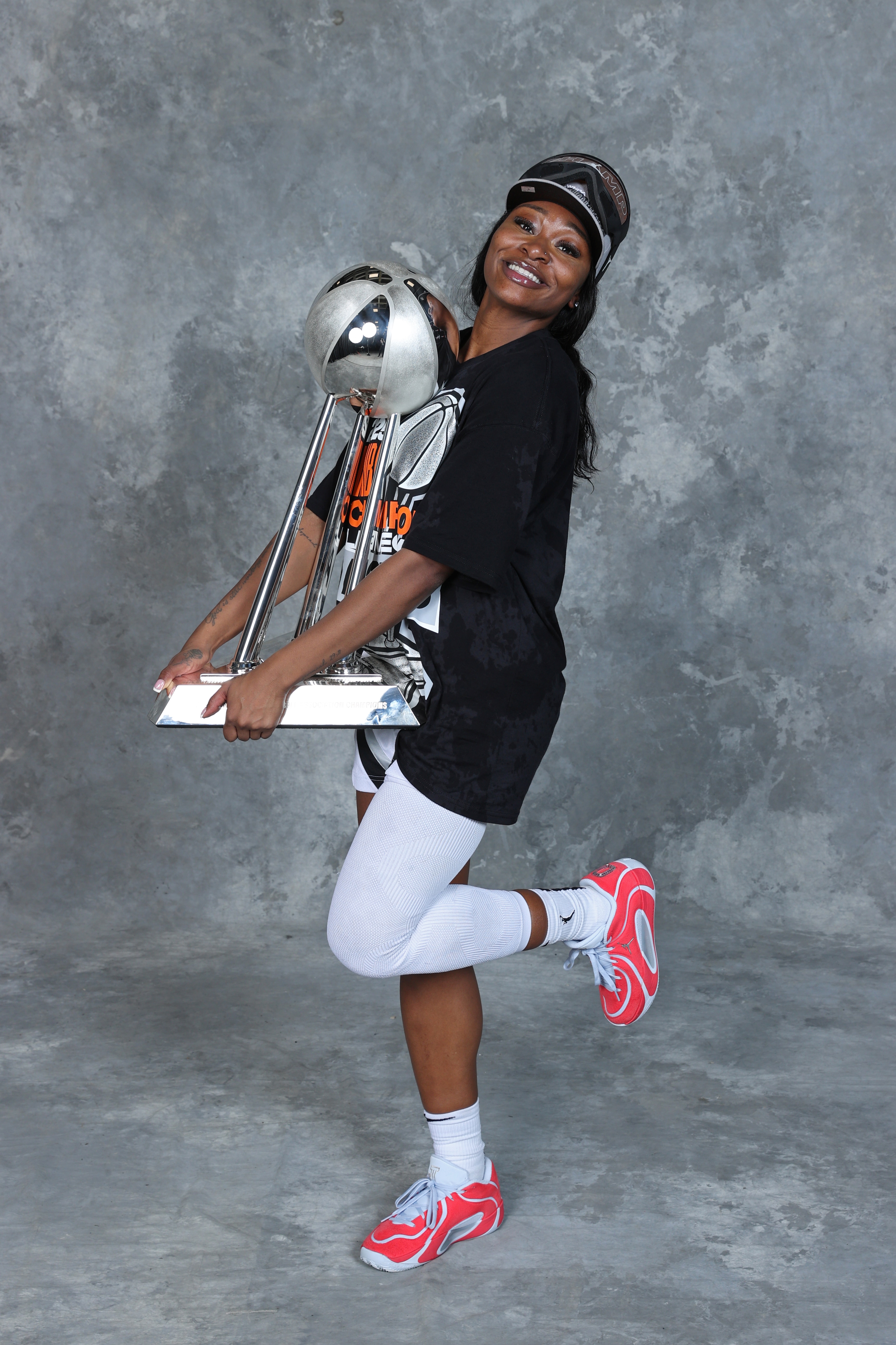 Dana Evans #11 of the Las Vegas Aces poses for a portrait with the 2025 WNBA Championship trophy