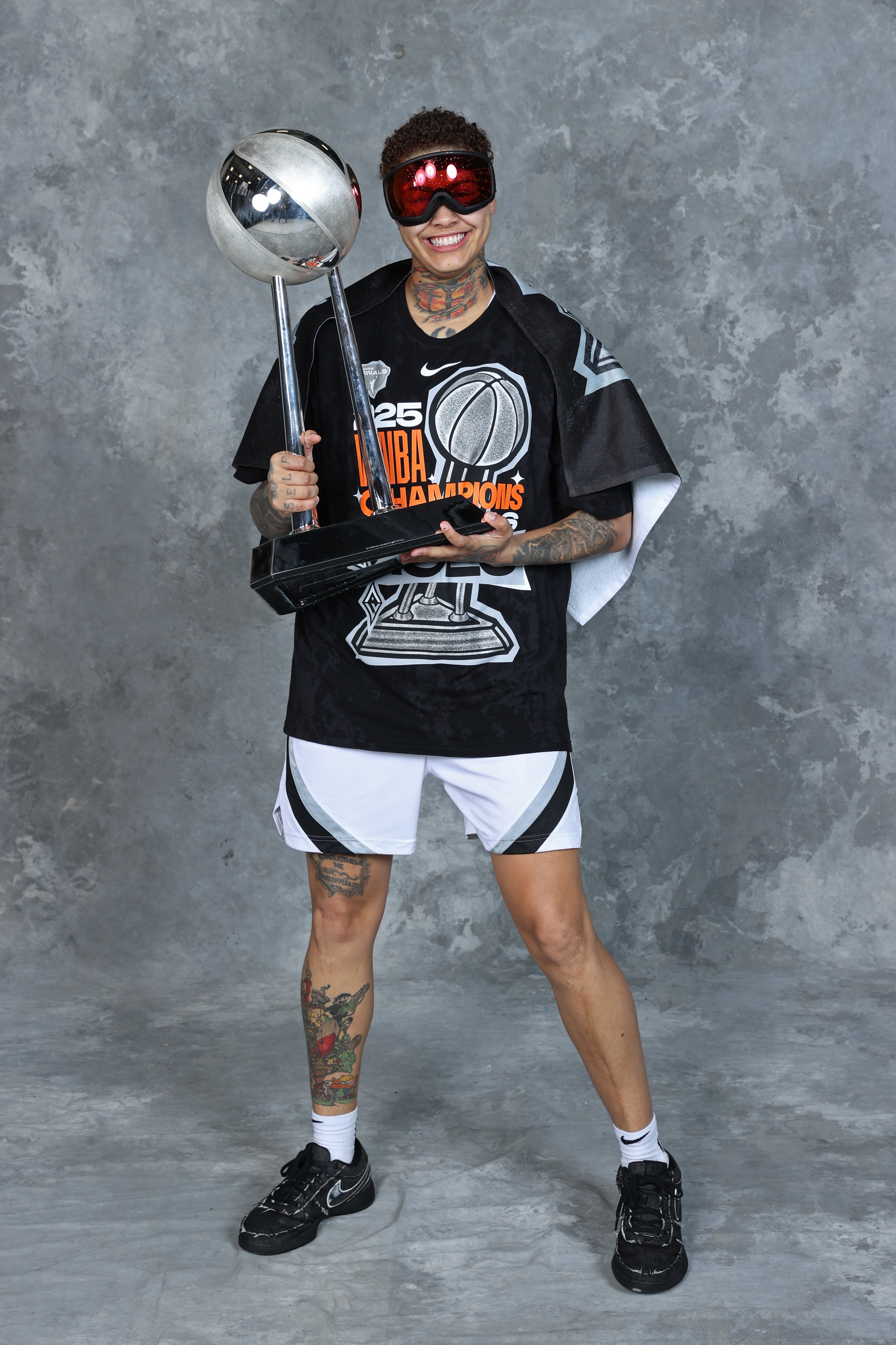 Kierstan Bell #1 of the Las Vegas Aces poses for a portrait with the 2025 WNBA Championship trophy