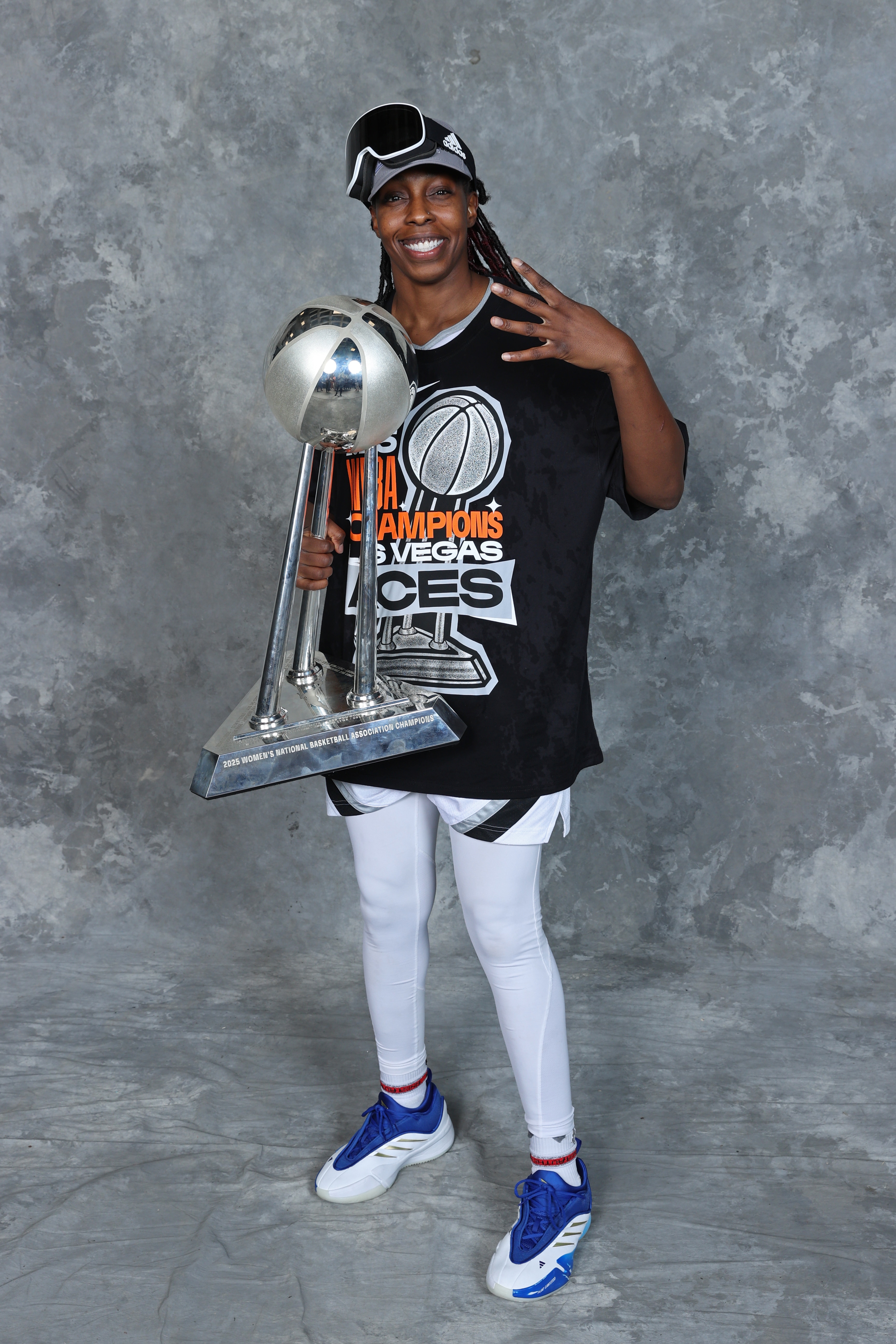 Chelsea Gray #12 of the Las Vegas Aces poses for a portrait with the 2025 WNBA Championship trophy