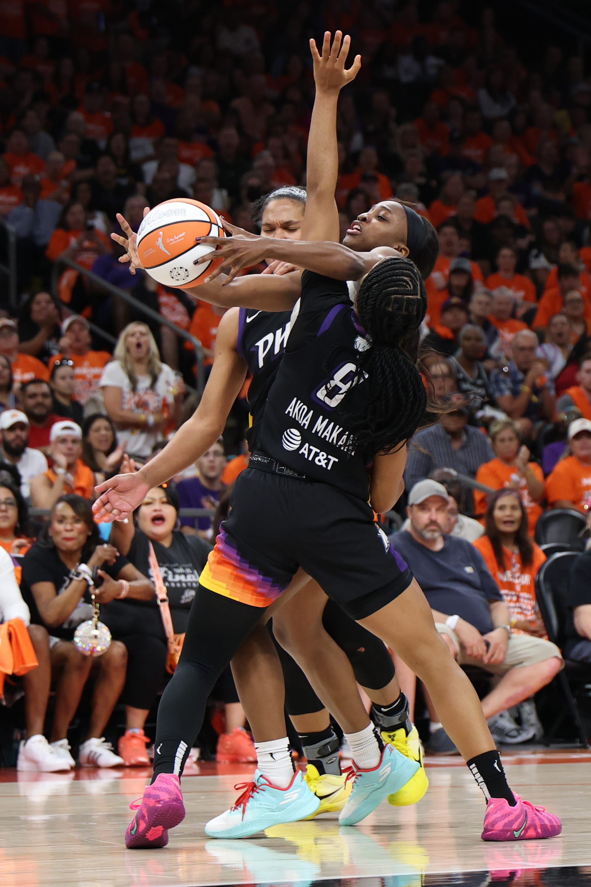 Jackie Young #0 of the Las Vegas Aces looks to shoot the ball between Alyssa Thomas #25 and Monique Akoa Makani #8 of the Phoenix Mercury