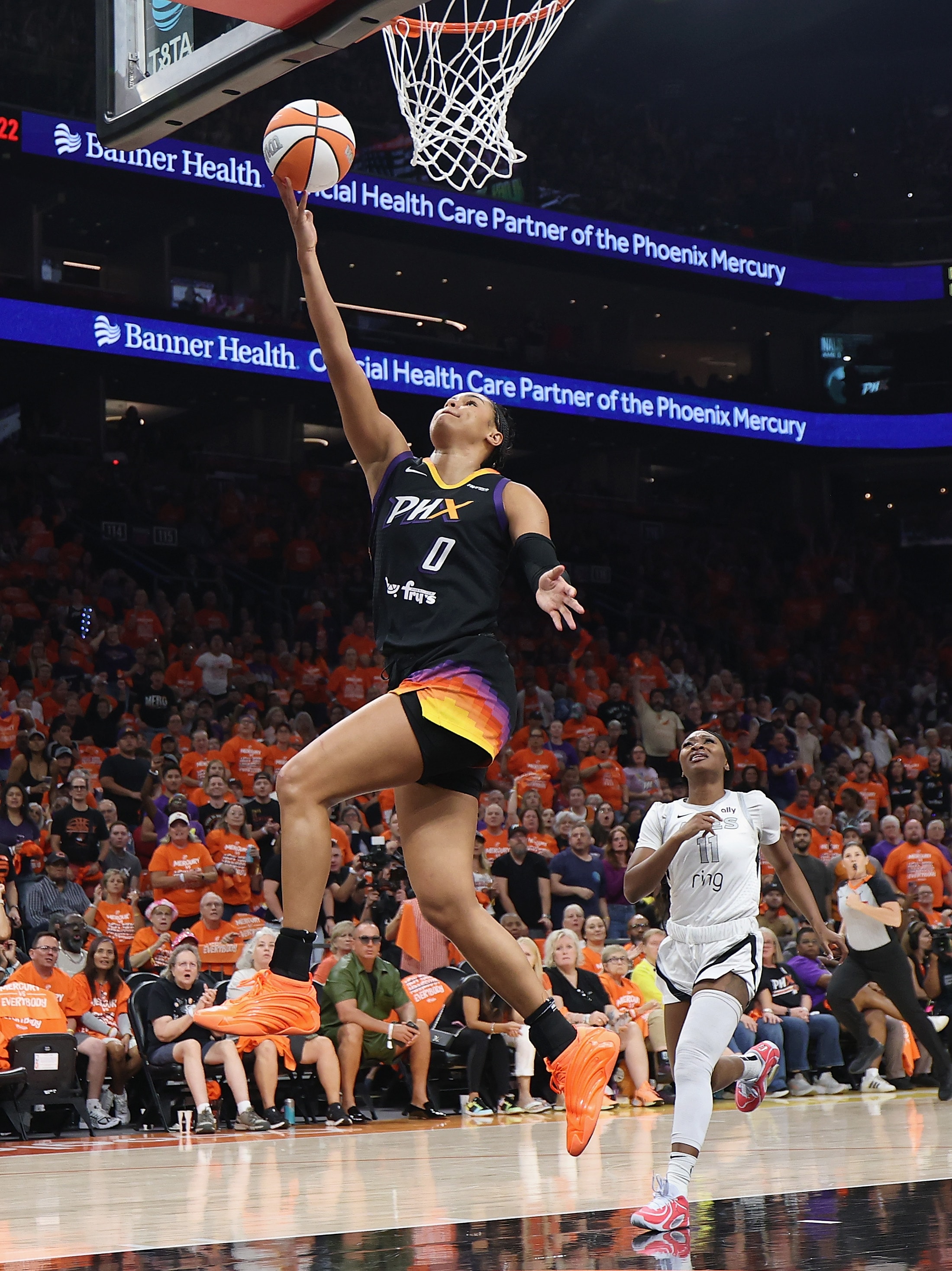 Satou Sabally #0 of the Phoenix Mercury lays up a shot ahead of Dana Evans #11 of the Las Vegas Aces