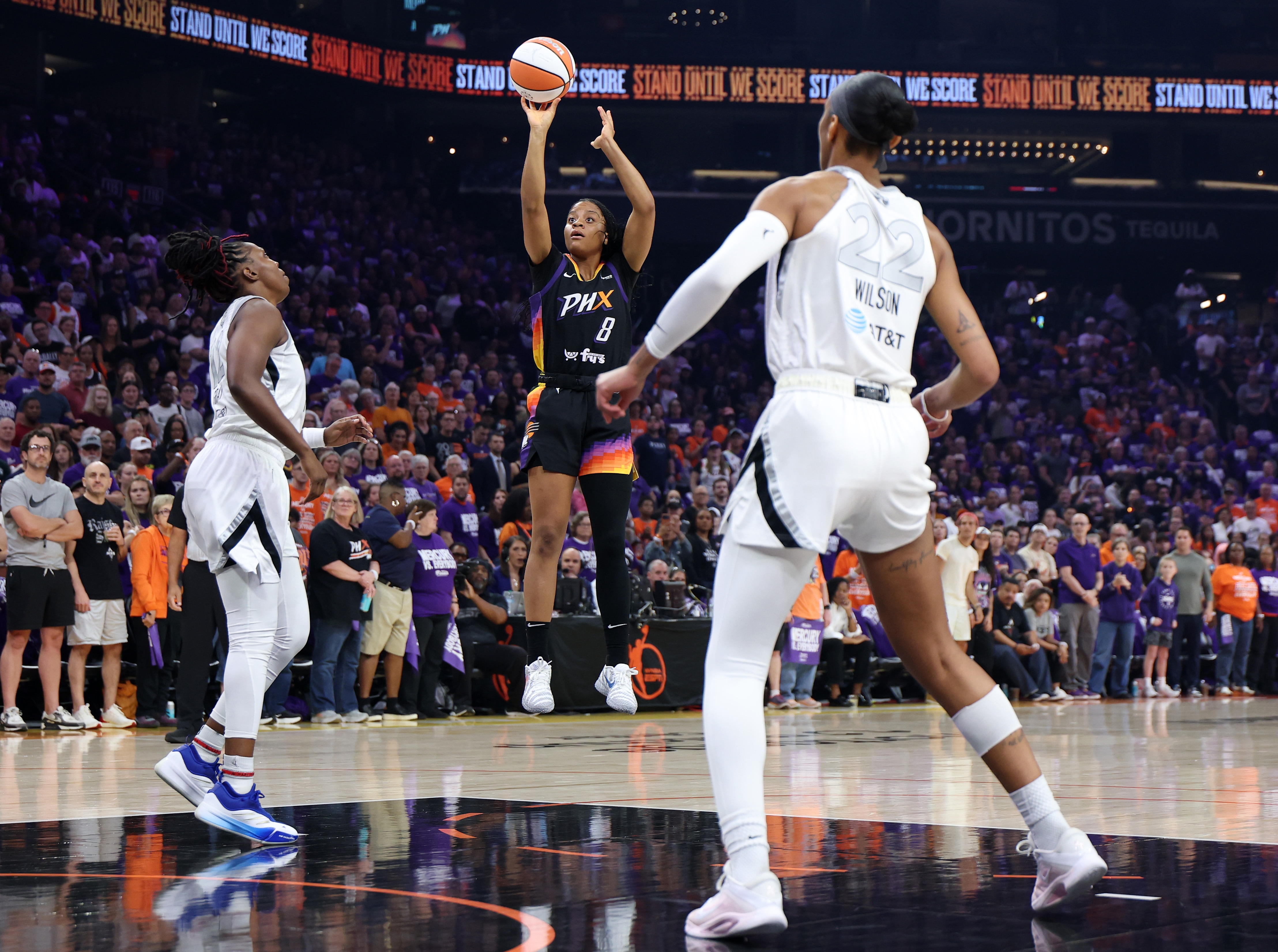 Monique Akoa Makani #8 of the Phoenix Mercury takes a shot while defended by Chelsea Gray #12 and A'ja Wilson #22 of the Las Vegas Aces
