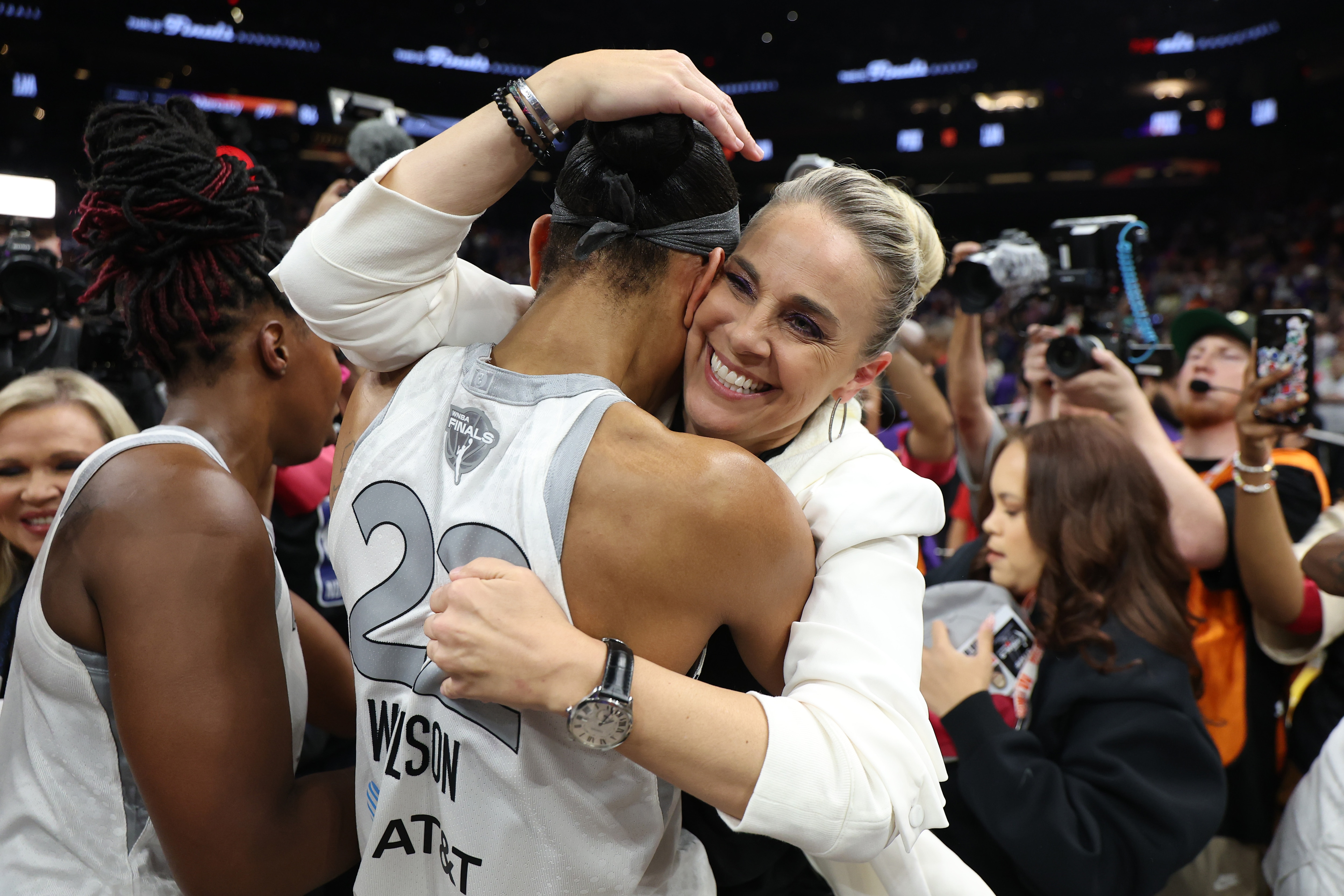 A'ja Wilson #22 of the Las Vegas Aces celebrates with head coach Becky Hammon after winning Game Four of the 2025 WNBA Playoffs finals