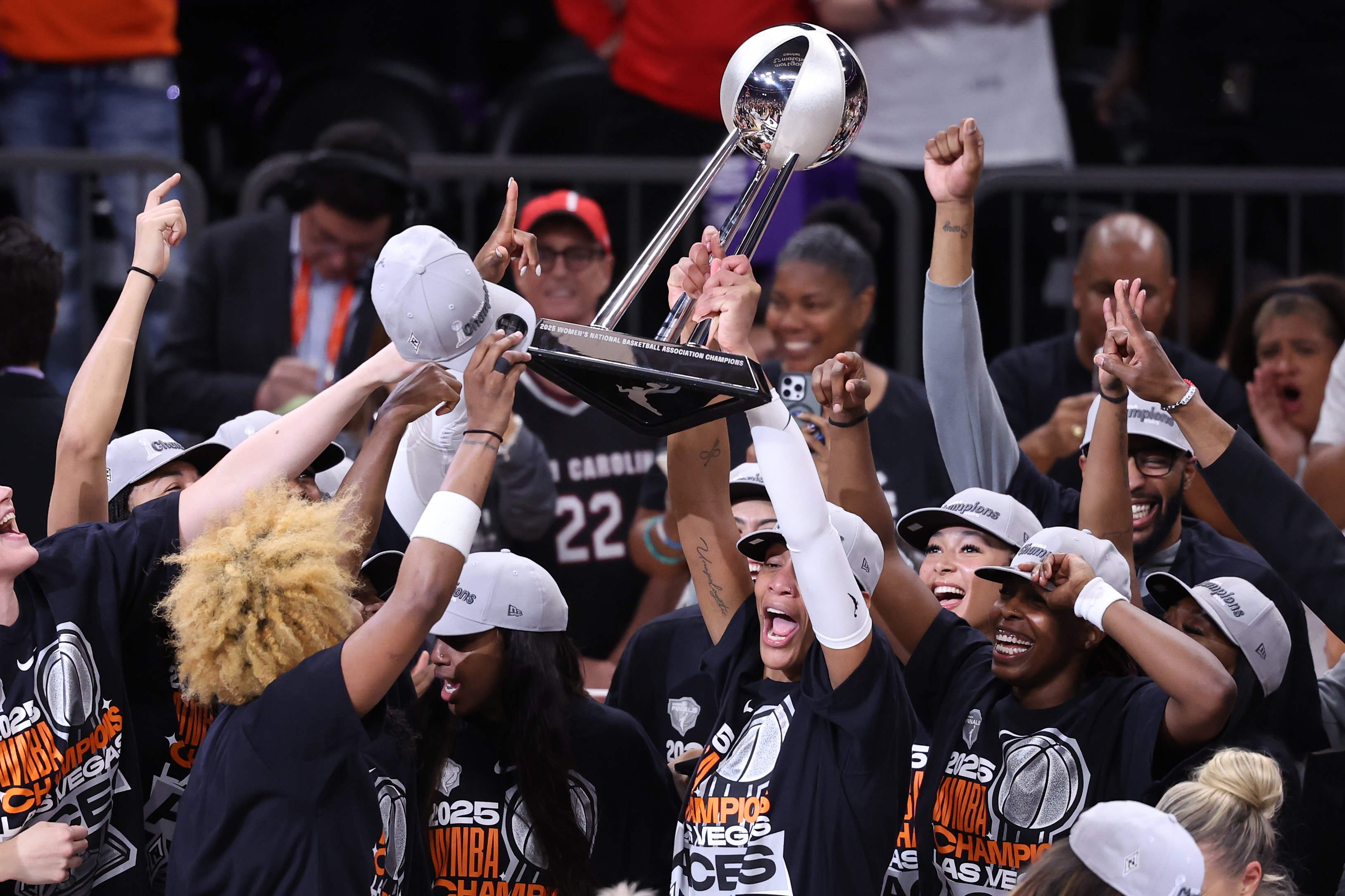 A'ja Wilson #22 of the Las Vegas Aces holds up the championship trophy after winning Game Four of the 2025 WNBA Finals
