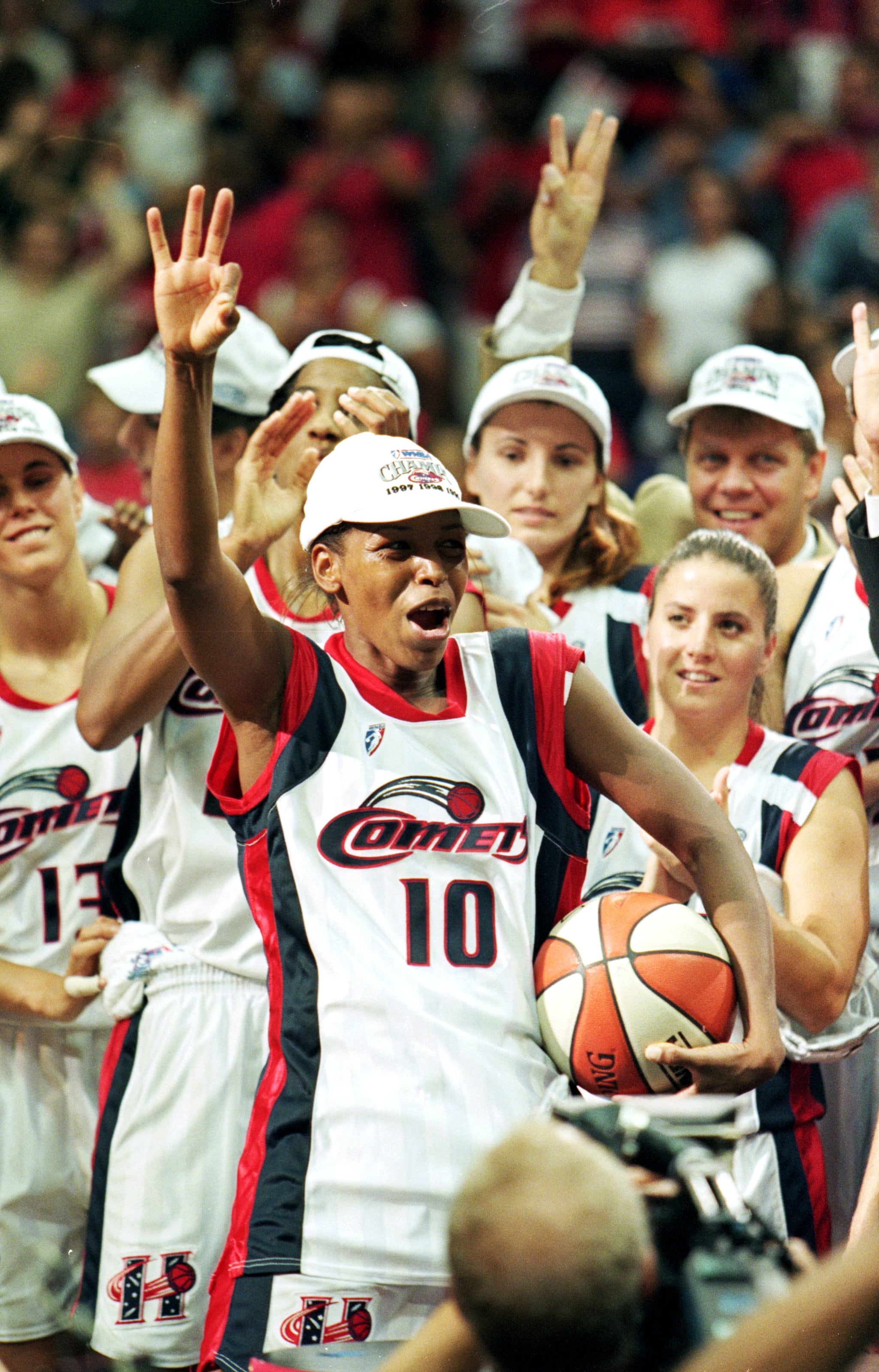 Cynthia Cooper #14 of the Houston Comets celebrates on the court by wearing jersey #10 in tribute to teammate Kim Perrot after winning game three of the WNBA Finals