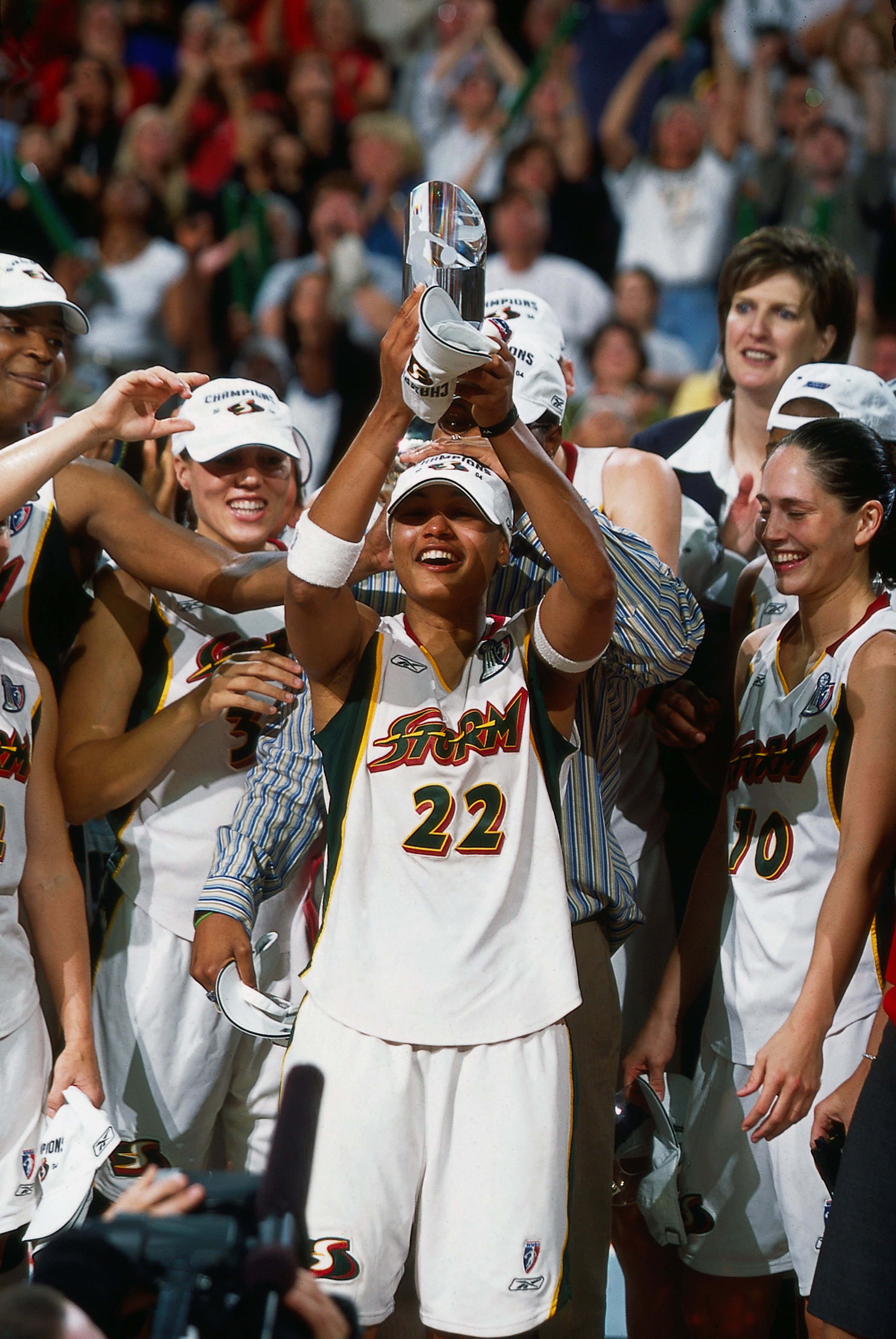 Betty Lennox #22 of the Seattle Storm holds up her 2004 WNBA Finals MVP trophy after defeating the Connecticut Sun in Game Three of the 2004 WNBA Finals