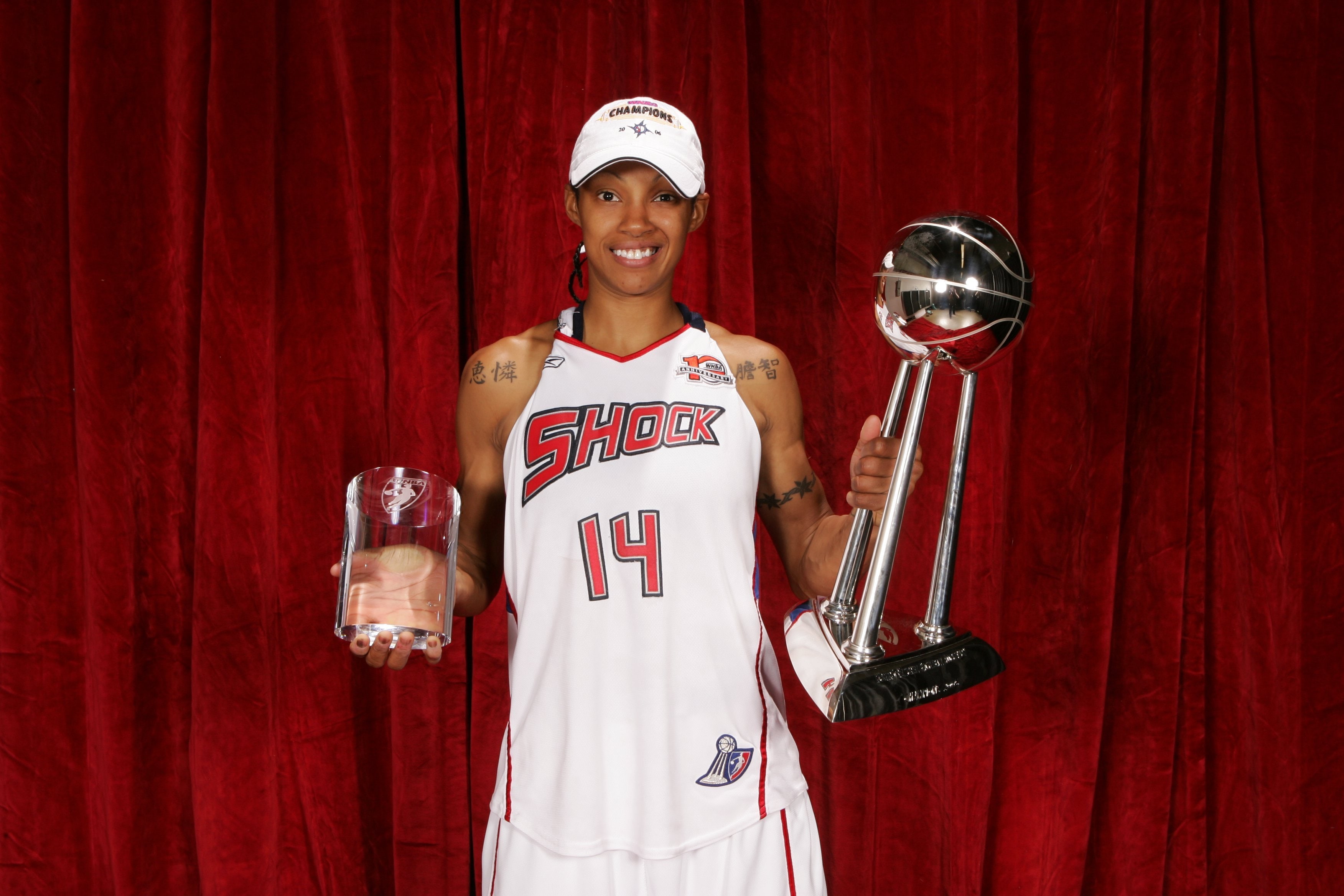 Deanna Nolan #14 of the 2006 WNBA Champion Detroit Shock celebrates with the WNBA Championship trophy and Most Valuable Player trophy