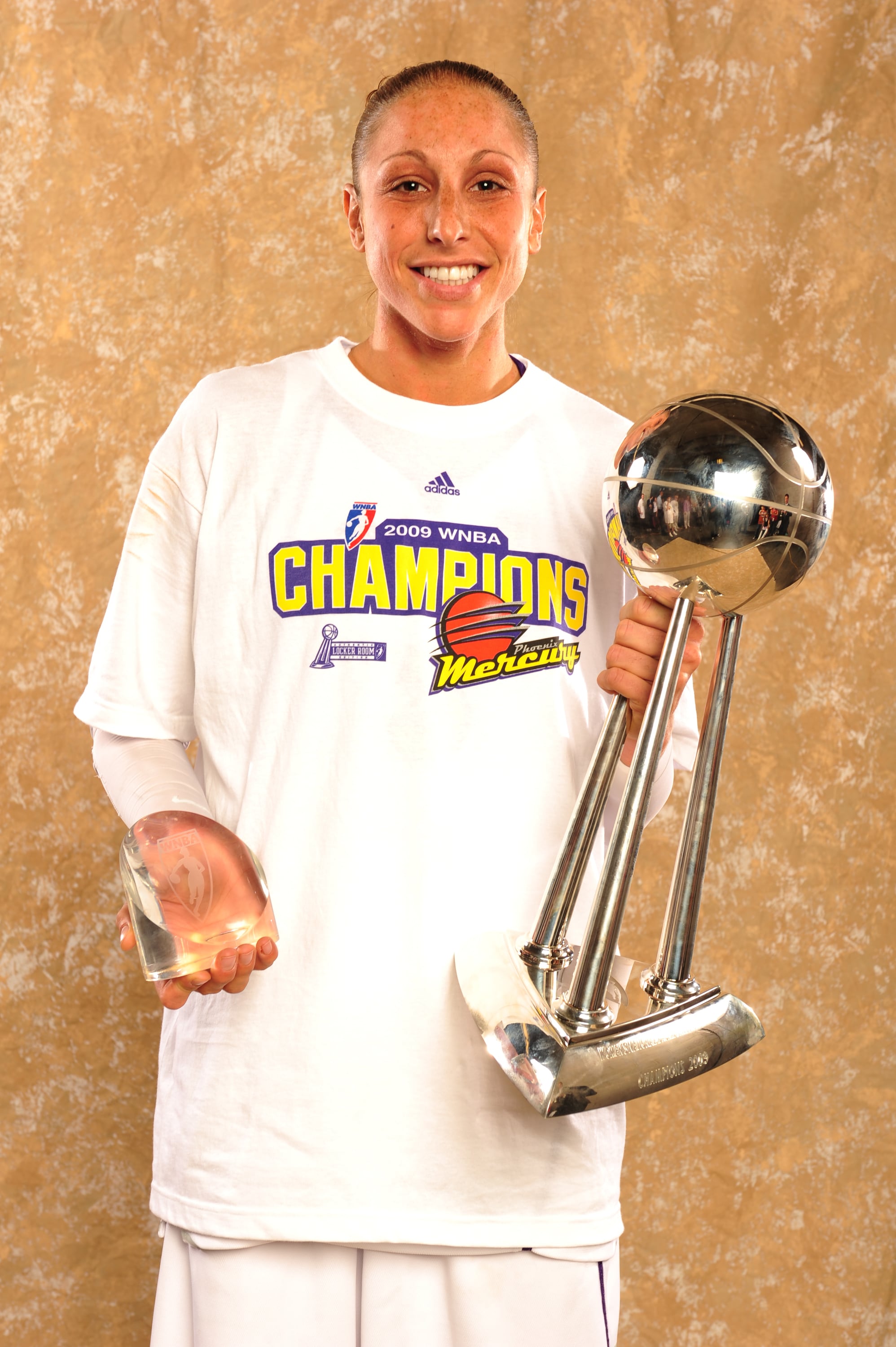Diana Taurasi #3 of the Phoenix Mercury poses with the WNBA Championship Trophy and her WNBA Finals MVP Award after the Mercury defeated the Indiana Fever 94-86 in Game five of the WNBA Finals
